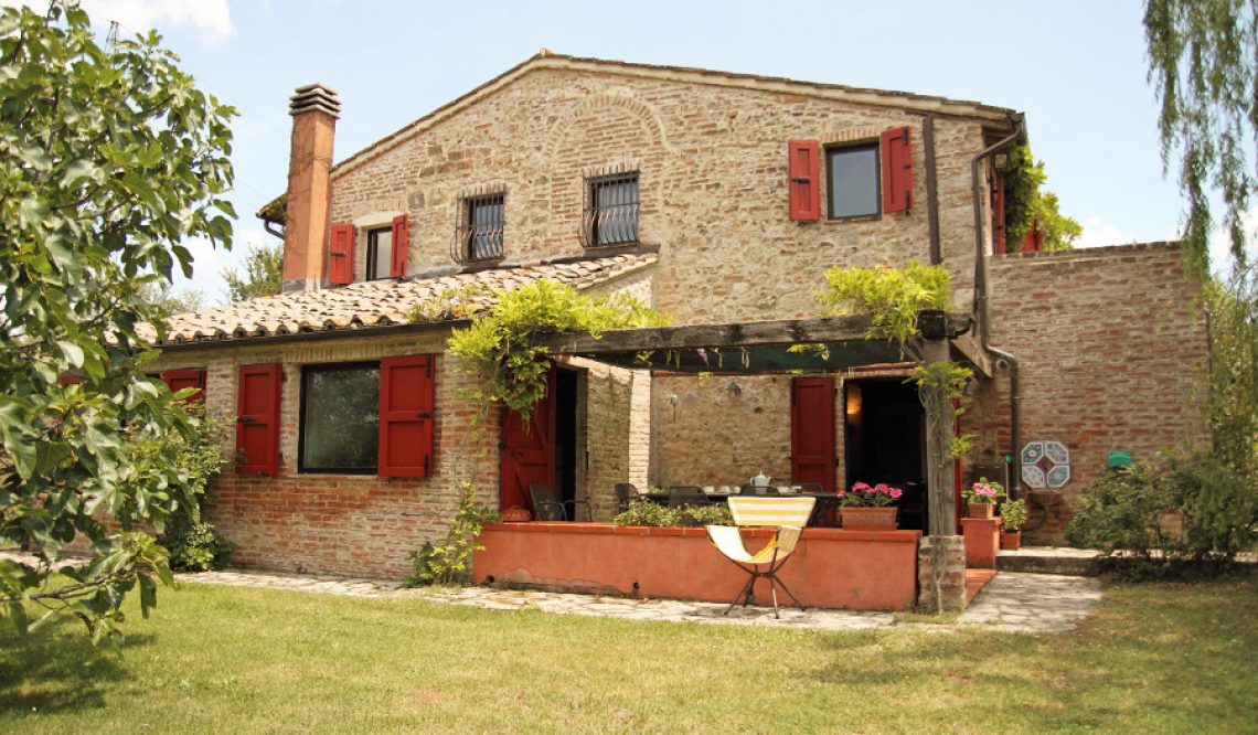 Country House with Red Windows among the Green Hills of Tuscany