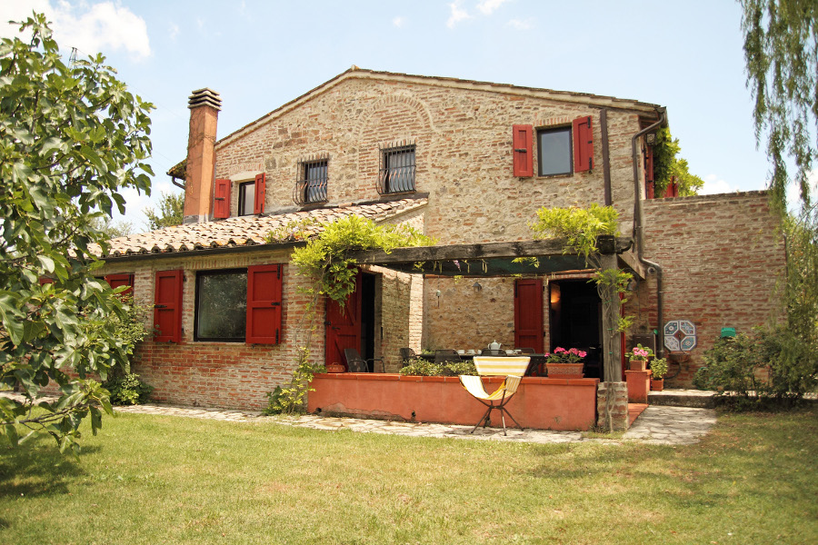 Country House with Red Windows among the Green Hills of Tuscany